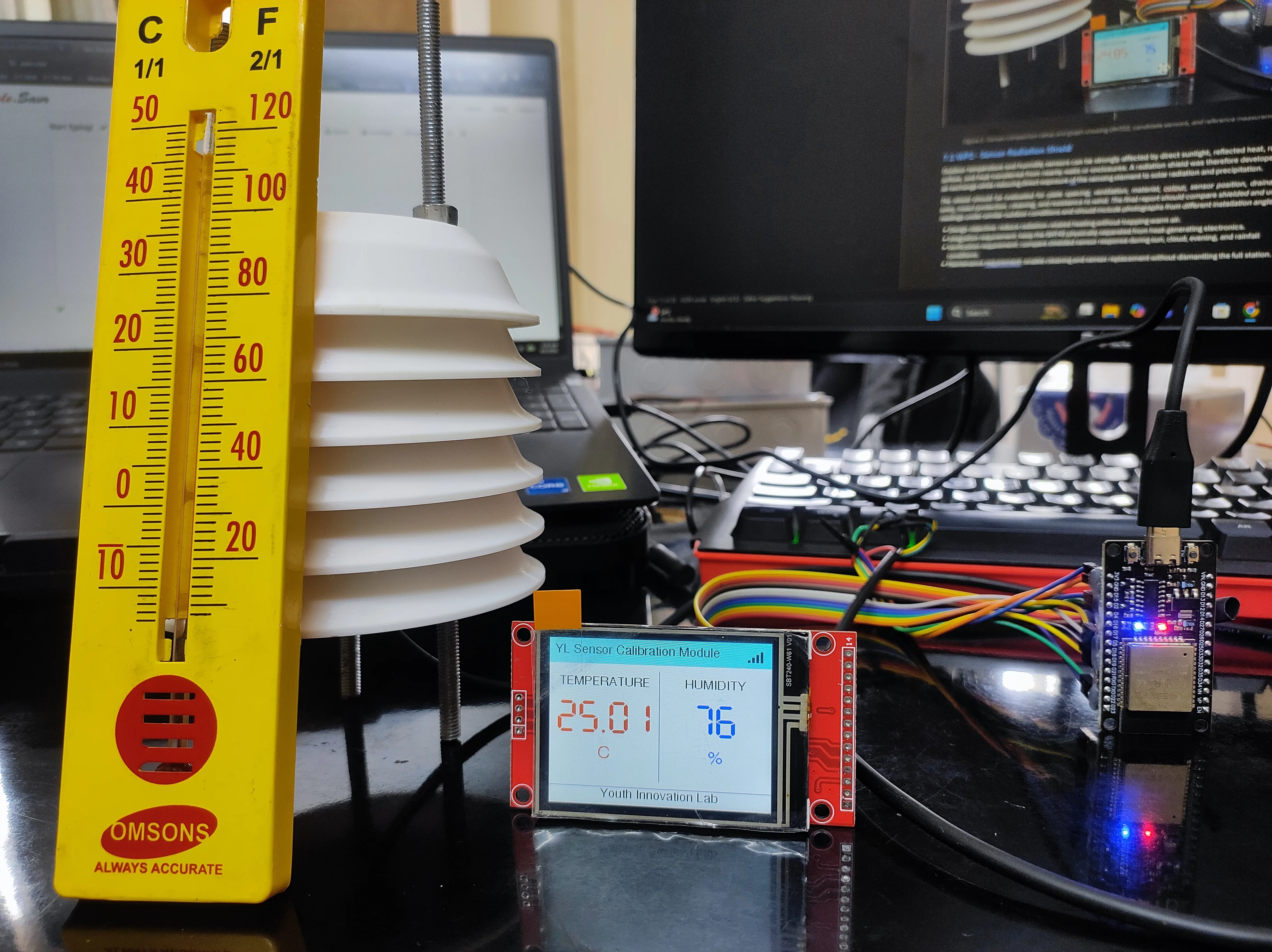 Real IoT hardware and embedded systems development setup with circuit boards, prototype devices, and lab test equipment.